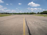 an airport has a broken section of the runway, with yellow lines drawn across it