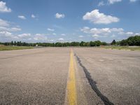 an airport has a broken section of the runway, with yellow lines drawn across it