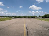 an airport has a broken section of the runway, with yellow lines drawn across it