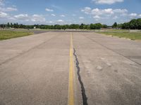 an airport has a broken section of the runway, with yellow lines drawn across it