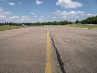 an airport has a broken section of the runway, with yellow lines drawn across it