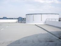a boat is parked in an empty parking lot near an air port on the water