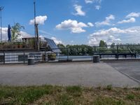 the benches are next to a lake on a sunny day and look out at clouds