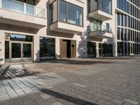 the sidewalk and the outside of a building with doors on them that are outside the buildings