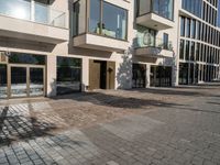 the sidewalk and the outside of a building with doors on them that are outside the buildings