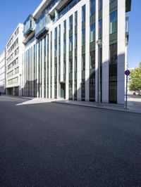 the building has several floors and has glass walls along the side of it, there are windows