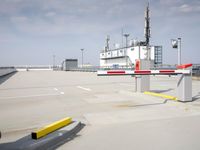 a boat is parked in an empty parking lot near an air port on the water