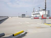 a boat is parked in an empty parking lot near an air port on the water