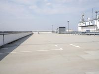 a boat is parked in an empty parking lot near an air port on the water