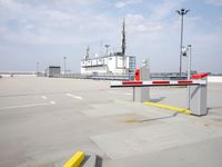 a boat is parked in an empty parking lot near an air port on the water