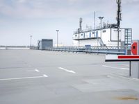 a boat is parked in an empty parking lot near an air port on the water