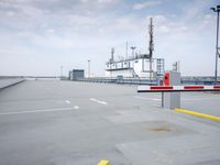 a boat is parked in an empty parking lot near an air port on the water