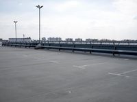 a boat is parked in an empty parking lot near an air port on the water