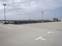 a boat is parked in an empty parking lot near an air port on the water