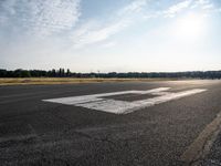 a view from an airport runway with a white line that runs from it to the right of the airplane