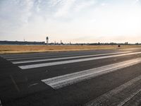 a photo taken on a runway of some sort with a few small planes near by