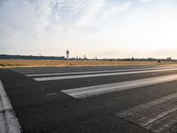 a photo taken on a runway of some sort with a few small planes near by