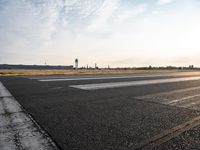 a photo taken on a runway of some sort with a few small planes near by