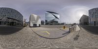 three 360 - generated spherical photographs of buildings in a city square, with street signs