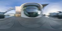 abstract photo of building at a city square with traffic and clouds in the background and light blue sky with white clouds