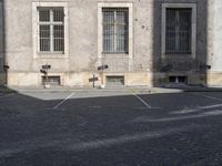 there is a street light outside a building in this town square area of a city