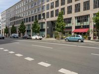 the white lines are painted on the street in front of buildings with stores and restaurants