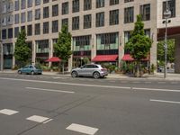 the white lines are painted on the street in front of buildings with stores and restaurants