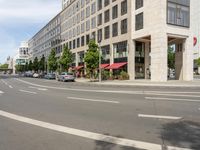 the white lines are painted on the street in front of buildings with stores and restaurants