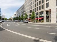 the white lines are painted on the street in front of buildings with stores and restaurants