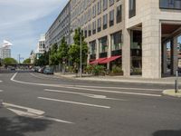 the white lines are painted on the street in front of buildings with stores and restaurants