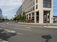 the white lines are painted on the street in front of buildings with stores and restaurants