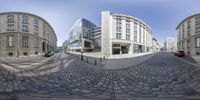 a 360 - shot lens is displayed to see an image of a city street with buildings and cars