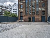 the street is full of cobblestone tiles as a building stands next to it