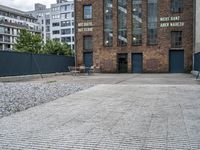 the street is full of cobblestone tiles as a building stands next to it