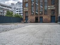 the street is full of cobblestone tiles as a building stands next to it