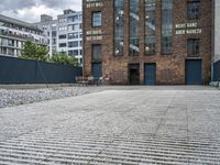 the street is full of cobblestone tiles as a building stands next to it