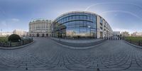 a fish eye lens shows an image of an empty city street with people walking around