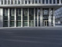 this is an image of a modern building on a city street with empty streets in the foreground