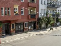 an image of city street that looks really narrow and empty looking outside from a balcony