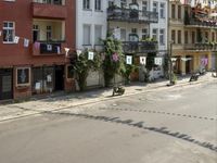 an image of city street that looks really narrow and empty looking outside from a balcony