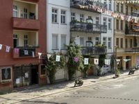 an image of city street that looks really narrow and empty looking outside from a balcony