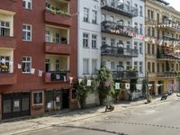 an image of city street that looks really narrow and empty looking outside from a balcony