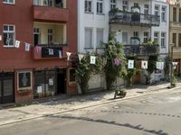 an image of city street that looks really narrow and empty looking outside from a balcony