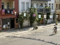 an image of city street that looks really narrow and empty looking outside from a balcony