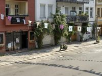 an image of city street that looks really narrow and empty looking outside from a balcony