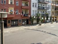 an image of city street that looks really narrow and empty looking outside from a balcony