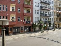 an image of city street that looks really narrow and empty looking outside from a balcony