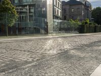 a city street with lots of glass walls and a sidewalk, trees and a walkway