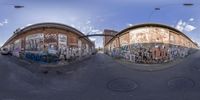 an upside down image of a city street with graffiti all over the place, as seen in a fisheye lens