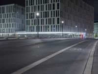 a very wide city street at night with no one in it's frame or frame